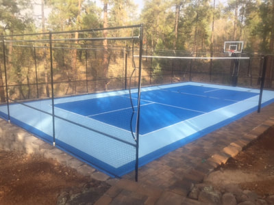 Construction taking place around a client's personal basketball court.